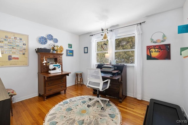 office space featuring baseboards and light wood-style floors