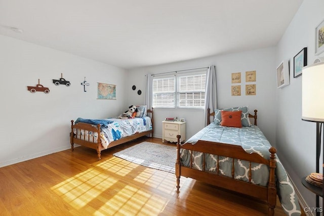 bedroom with wood finished floors and baseboards