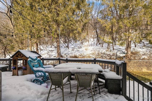 snow covered deck with fence