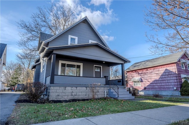 bungalow with a shingled roof and a porch