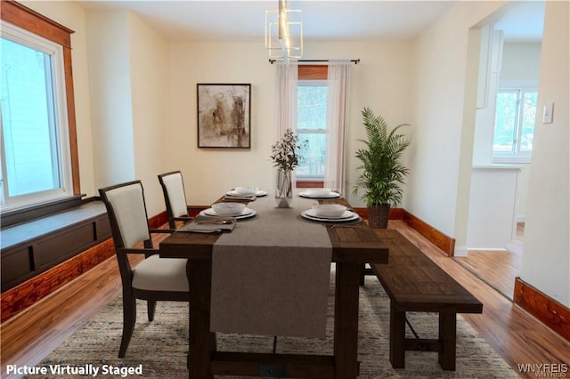 dining area featuring a wealth of natural light, baseboards, and wood finished floors