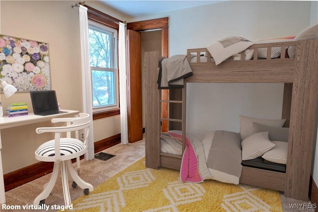 carpeted bedroom with baseboards and visible vents