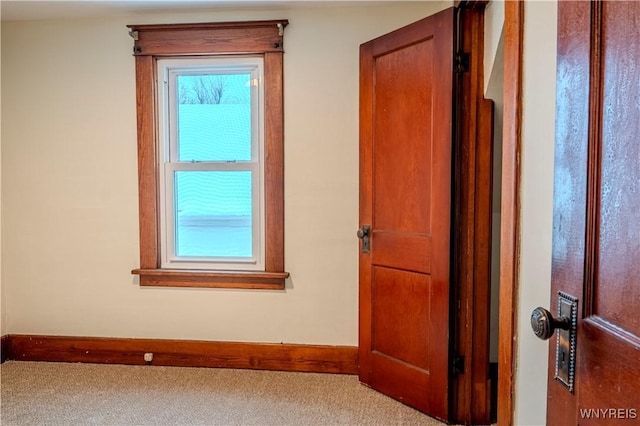 interior space featuring carpet floors and baseboards