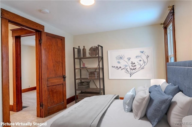 bedroom featuring carpet flooring and baseboards