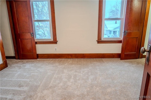 spare room with carpet flooring and baseboards