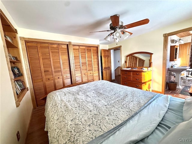 bedroom with multiple closets, ceiling fan, and baseboards