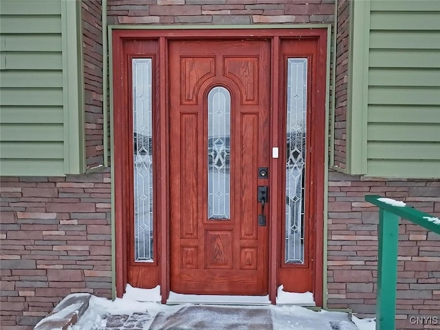 property entrance with brick siding