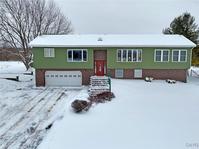 split foyer home with a garage and brick siding