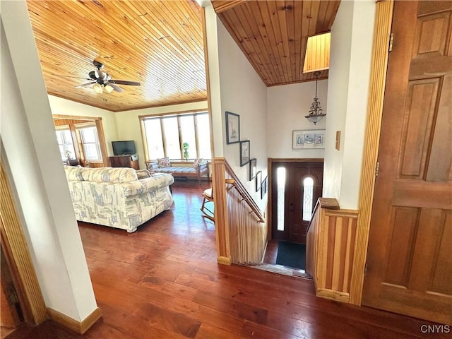 entrance foyer with lofted ceiling, wood ceiling, ceiling fan, dark wood-type flooring, and crown molding