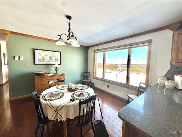 dining space featuring ornamental molding, baseboards, and dark wood-style floors