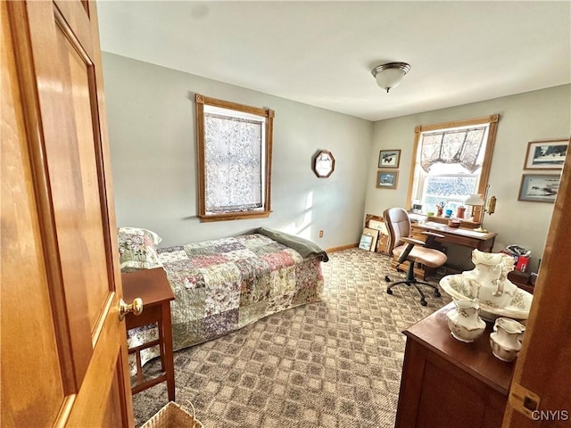 carpeted bedroom with baseboards