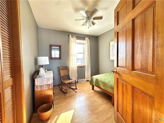 bedroom with light wood finished floors and baseboards