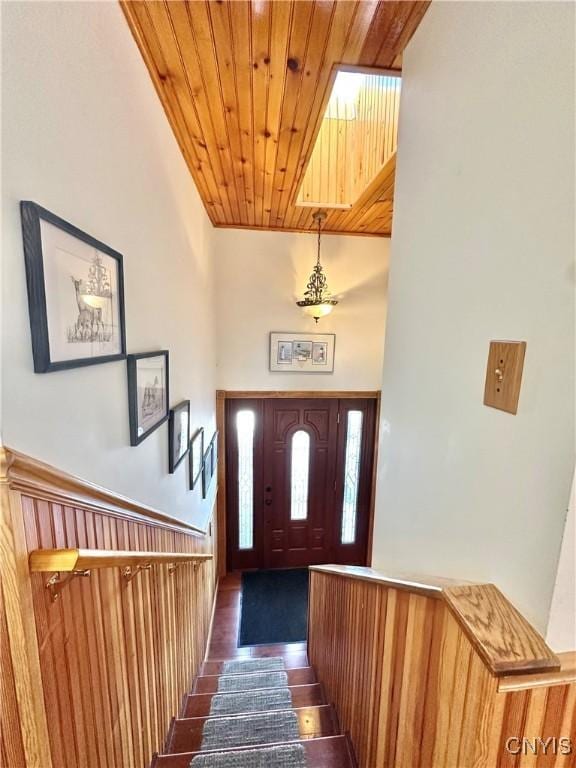 entrance foyer with dark wood-style floors and wood ceiling