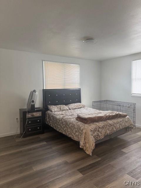 bedroom featuring dark wood-style floors and baseboards