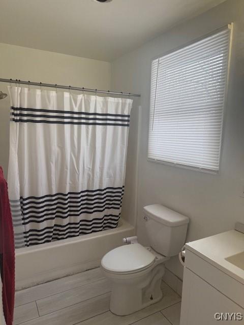 bathroom featuring shower / bath combo, vanity, and toilet