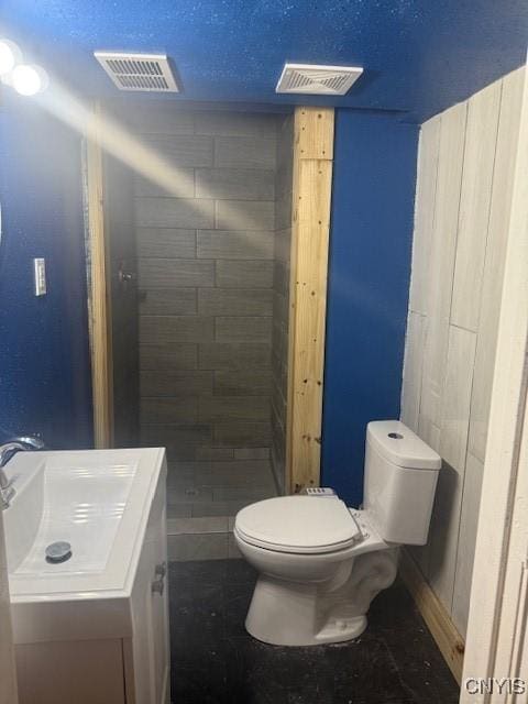 full bathroom with toilet, a shower stall, visible vents, and vanity