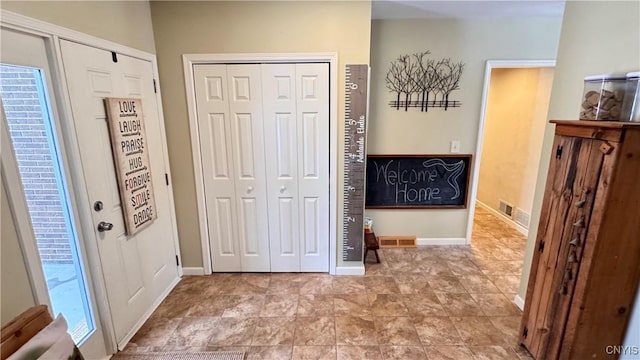 entryway with baseboards and visible vents