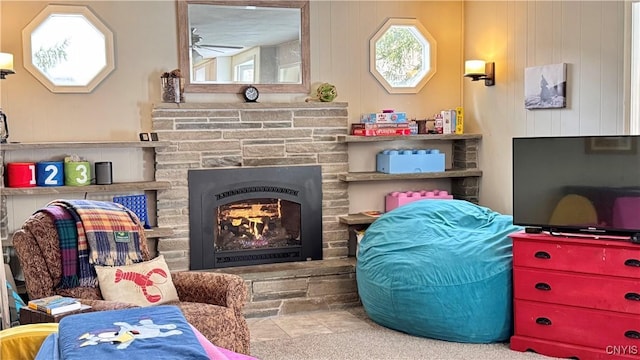 living area featuring a stone fireplace