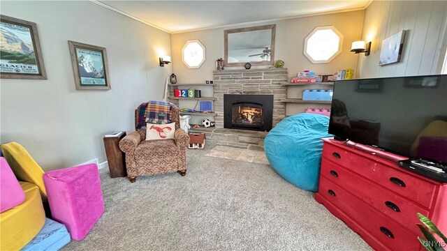 sitting room featuring carpet floors, plenty of natural light, a fireplace, and ornamental molding