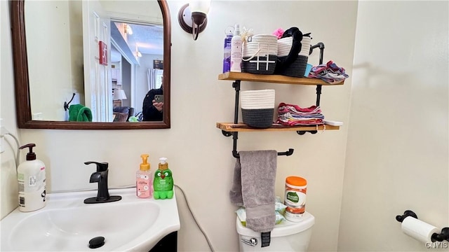 half bath featuring toilet and a sink