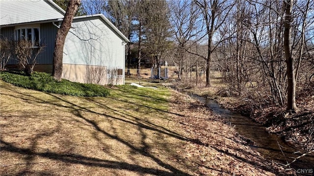 view of home's exterior featuring a trampoline and a lawn