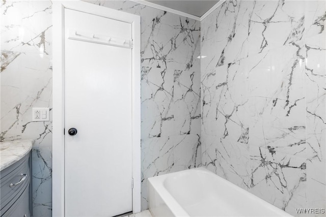 bathroom with stone wall, crown molding, and vanity