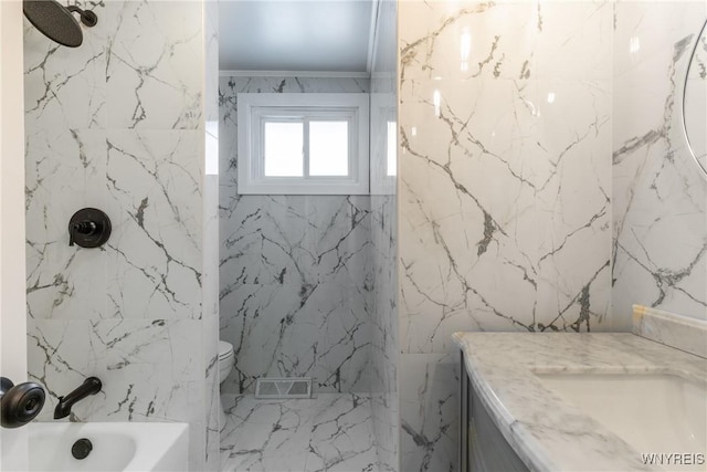 full bathroom featuring visible vents, stone wall, tub / shower combination, and vanity