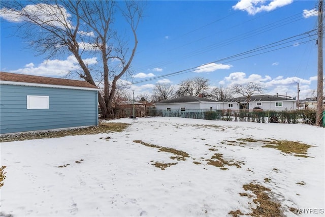 snowy yard with fence