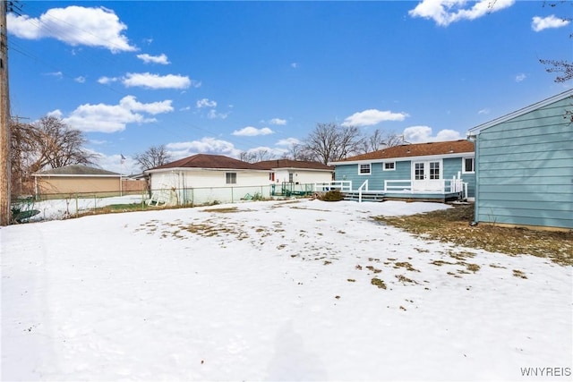 snow covered property featuring fence