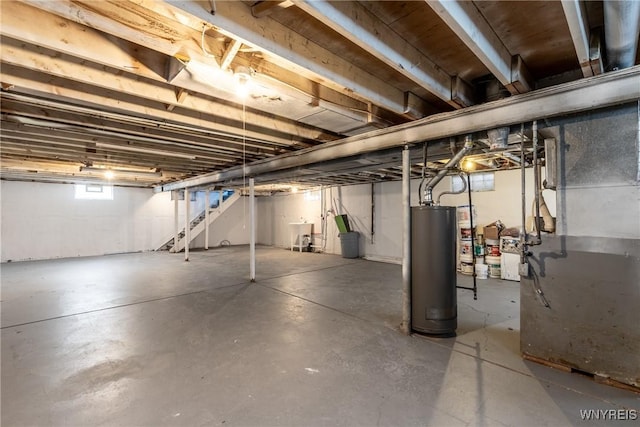 basement featuring heating unit and water heater