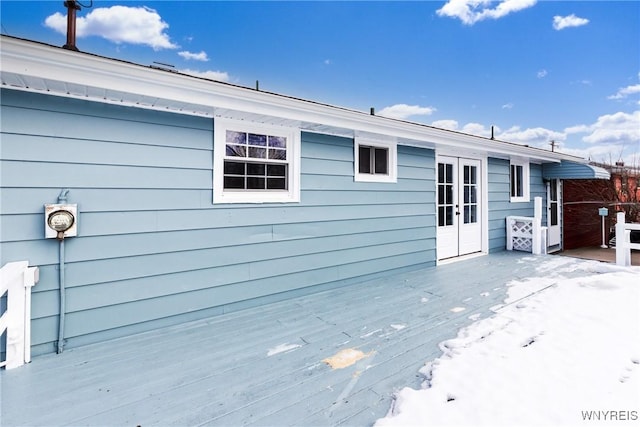 rear view of property with french doors and a wooden deck