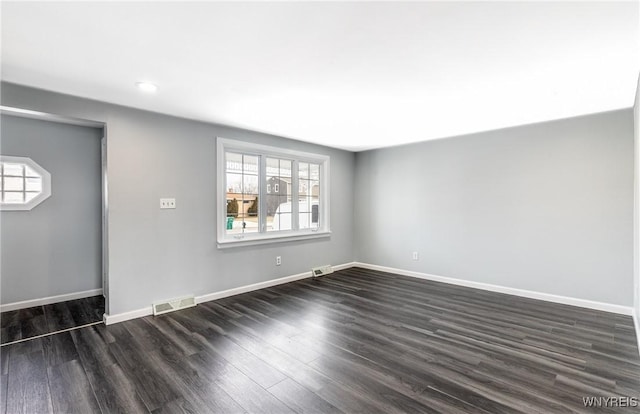 unfurnished living room featuring baseboards, visible vents, and a wealth of natural light