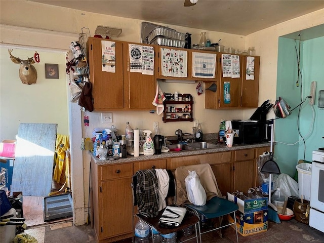 kitchen with black microwave, brown cabinetry, and a sink