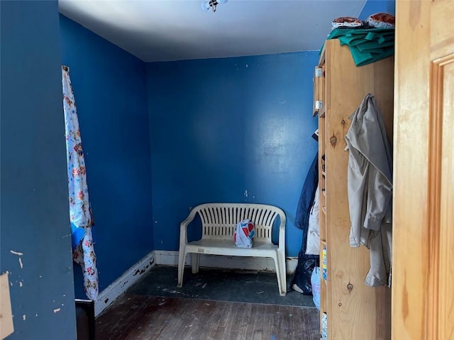 bedroom with wood finished floors and baseboards