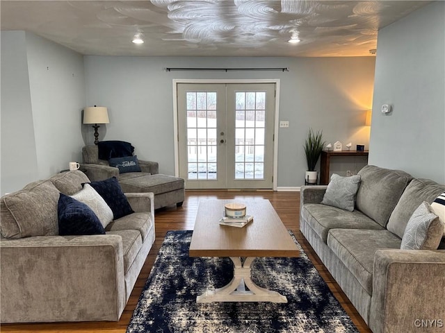 living room with french doors, baseboards, and wood finished floors