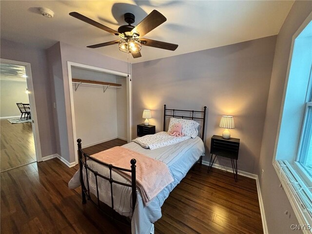 bedroom with a ceiling fan, a closet, baseboards, and wood finished floors