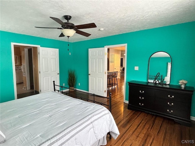 bedroom featuring a textured ceiling, ceiling fan, wood finished floors, and baseboards