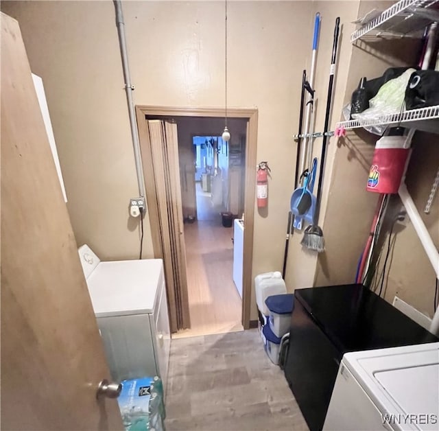 interior space with laundry area and wood finished floors