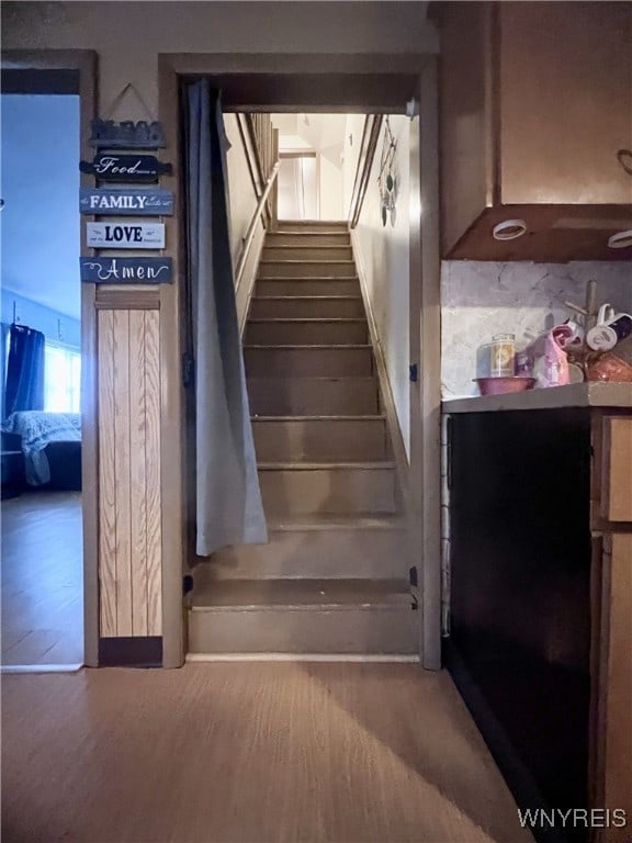 stairway with wood finished floors