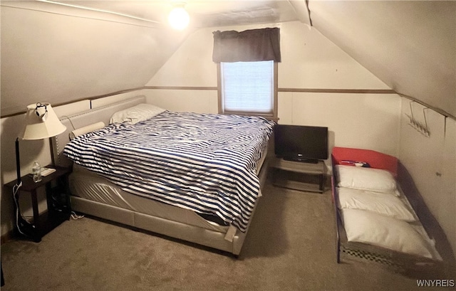 bedroom with carpet flooring and vaulted ceiling