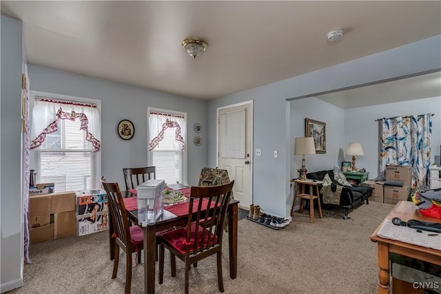 dining space with light colored carpet