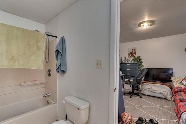 bathroom featuring toilet and tub / shower combination