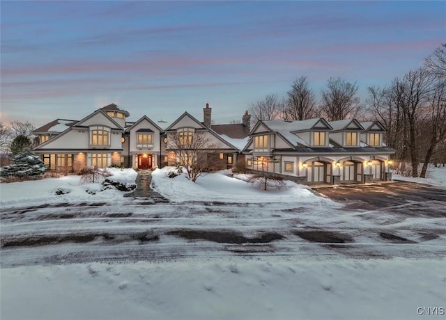 view of front of home featuring driveway and a chimney