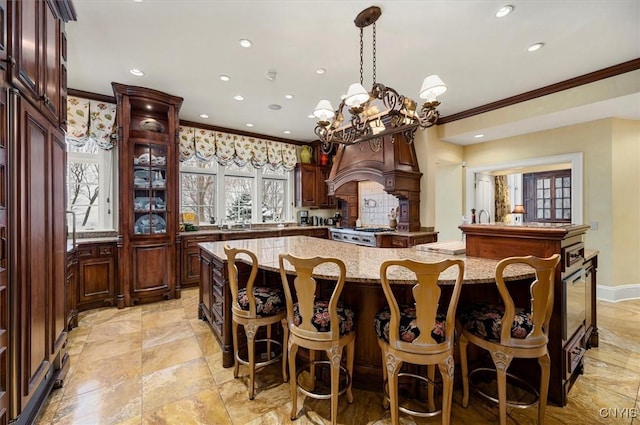 3789 State Route 12, Kirkland, NY 13323 - kitchen with a large island, recessed lighting, ornamental molding, decorative light fixtures, and light stone countertops
