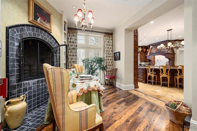 3789 State Route 12, Kirkland, NY 13323 - dining space with crown molding, a notable chandelier, a high end fireplace, wood finished floors, and baseboards