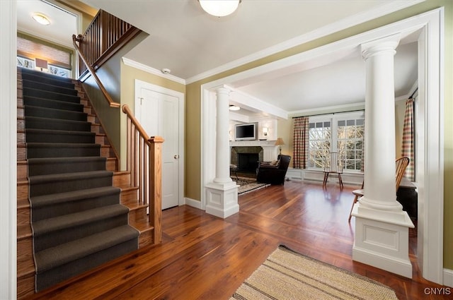 3789 State Route 12, Kirkland, NY 13323 - entrance foyer with a fireplace, wood finished floors, baseboards, ornamental molding, and decorative columns