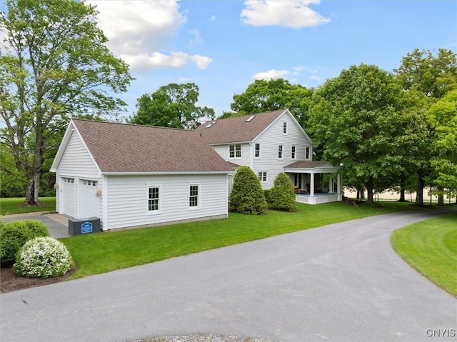 3789 State Route 12, Kirkland, NY 13323 - view of front of house with a garage, roof with shingles, a front lawn, and asphalt driveway
