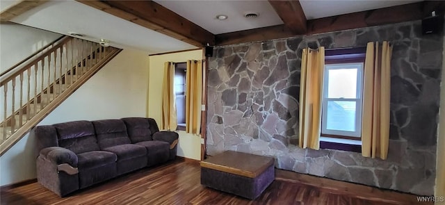 living room featuring visible vents, stairs, wood finished floors, and beam ceiling