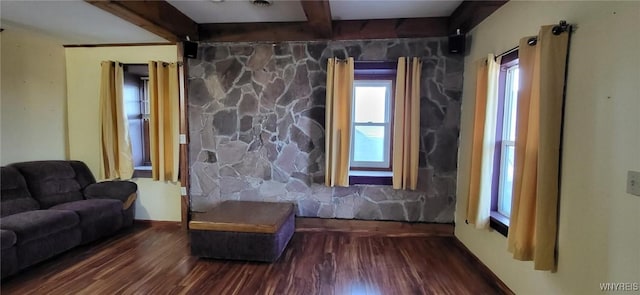 sitting room with beam ceiling and wood finished floors