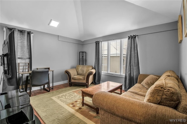 living room with lofted ceiling, baseboards, and wood finished floors